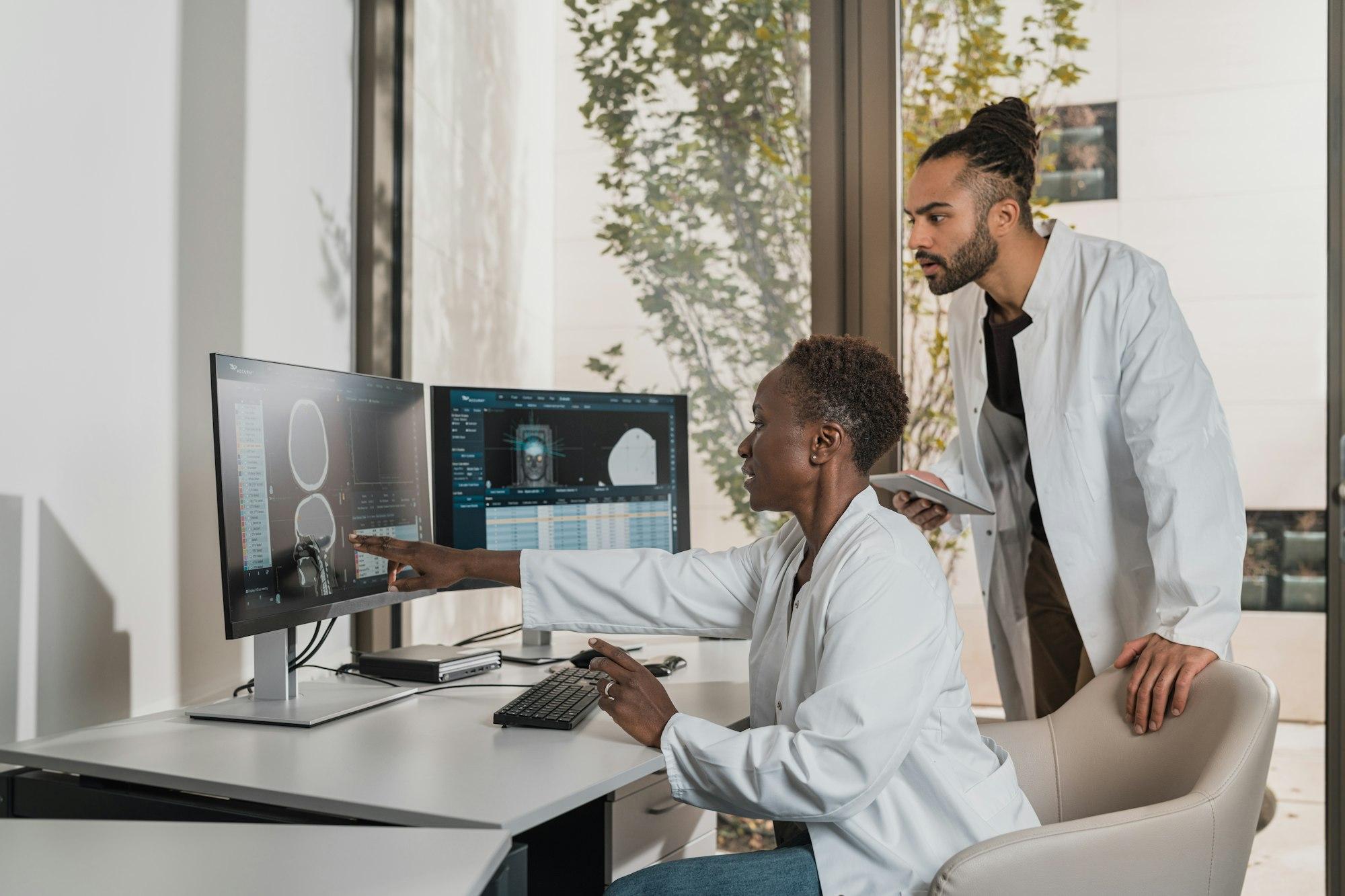 Doctors reviewing patient records on screen