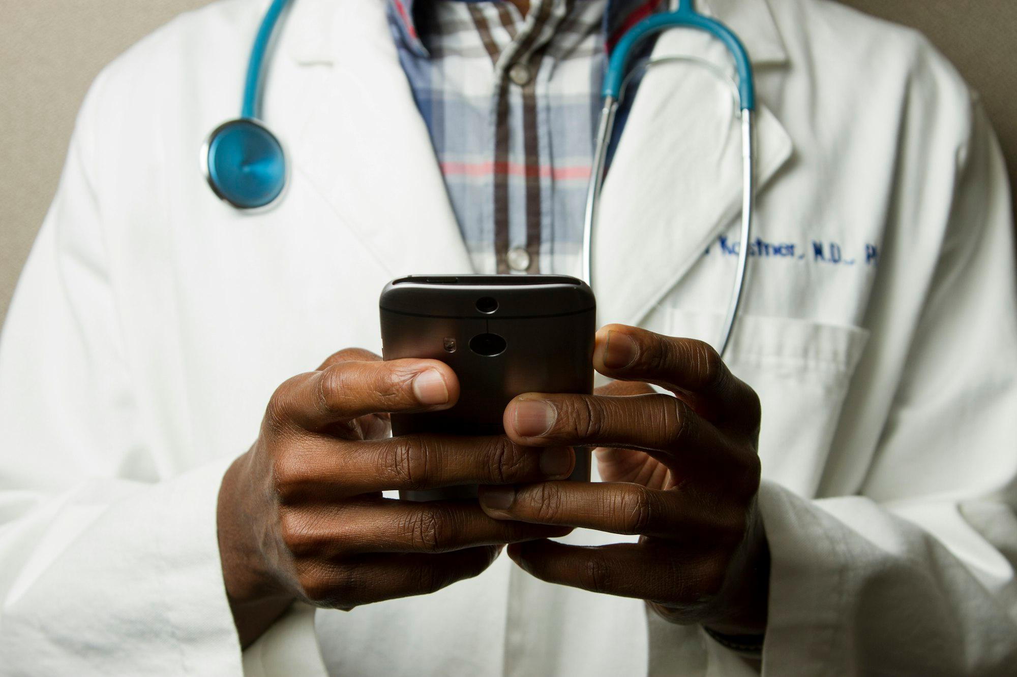 A doctor sending updates from a phone